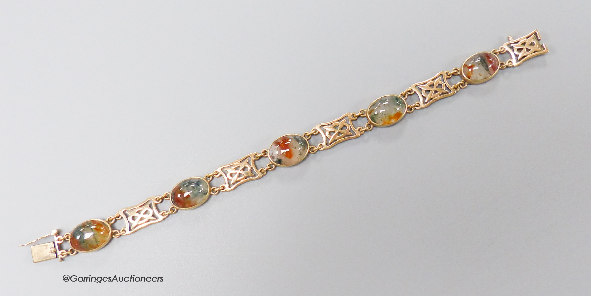 A modern 9ct gold and five stone oval cabochon moss agate and gate link set bracelet, 18.3cm, gross weight 16.9 grams.